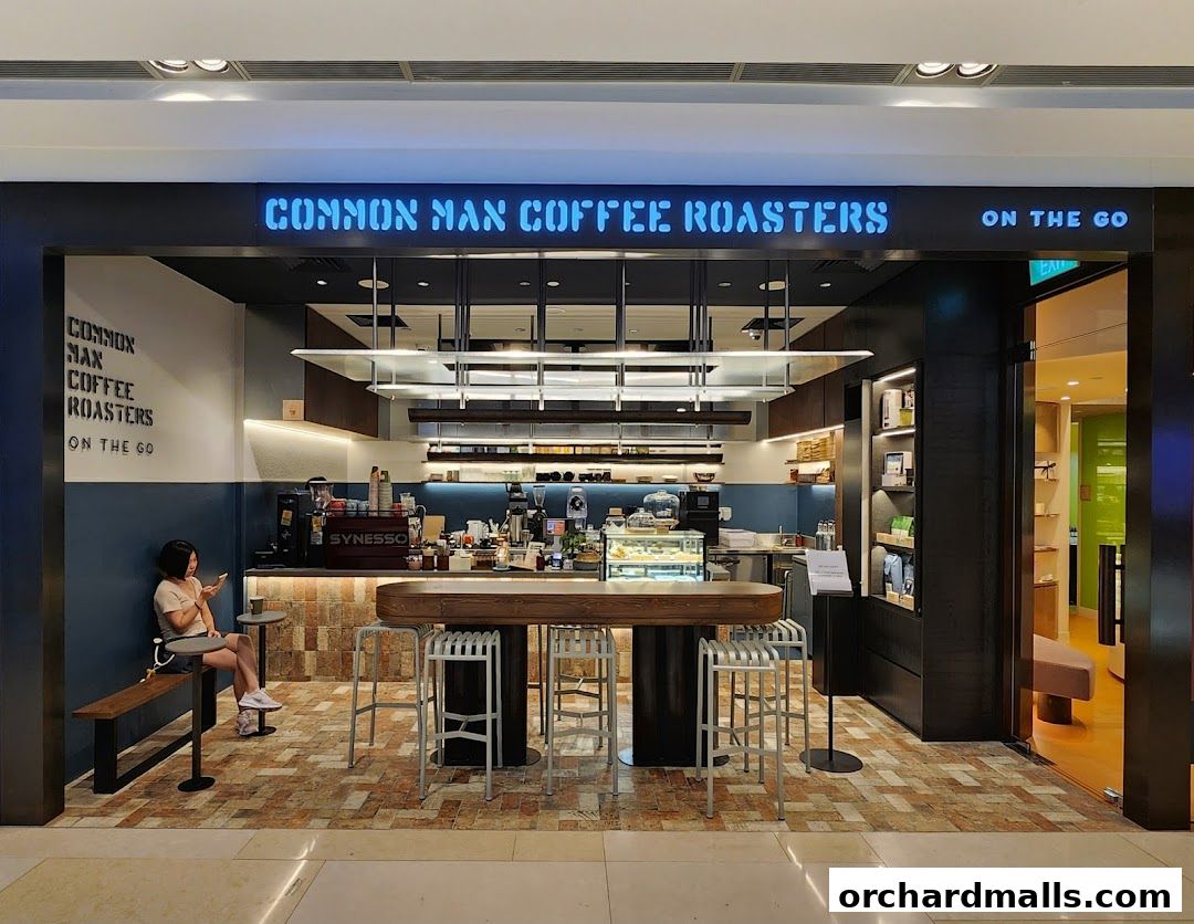 The exterior of Common Man Coffee Roasters - On The Go, featuring a counter and seating.