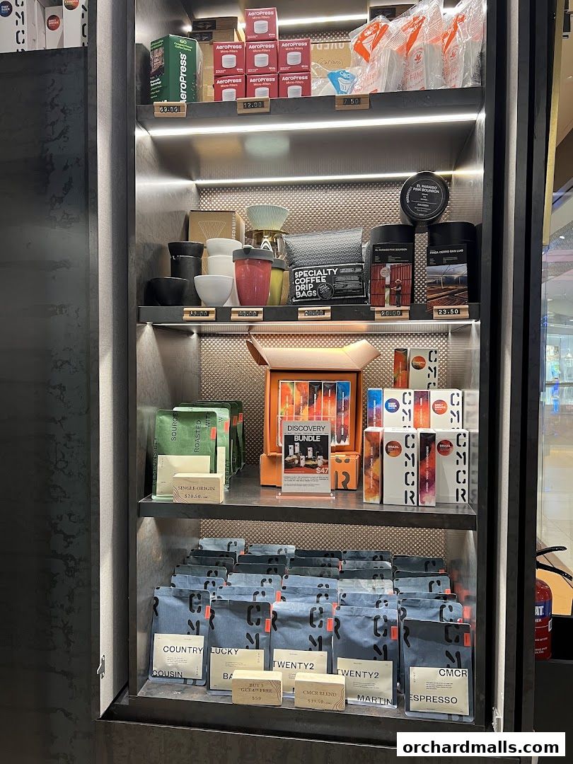 A display shelf showcasing various coffee products, brewing equipment, and accessories.