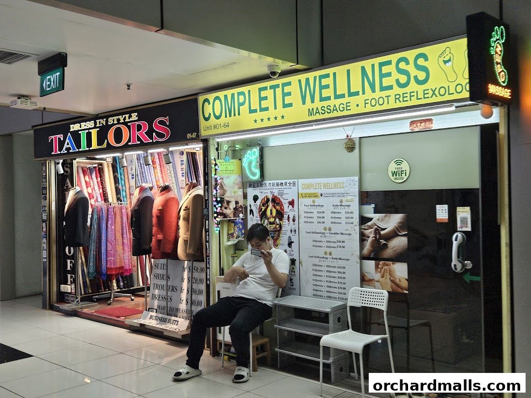 A storefront featuring a tailor shop and a wellness center offering massage and reflexology services.