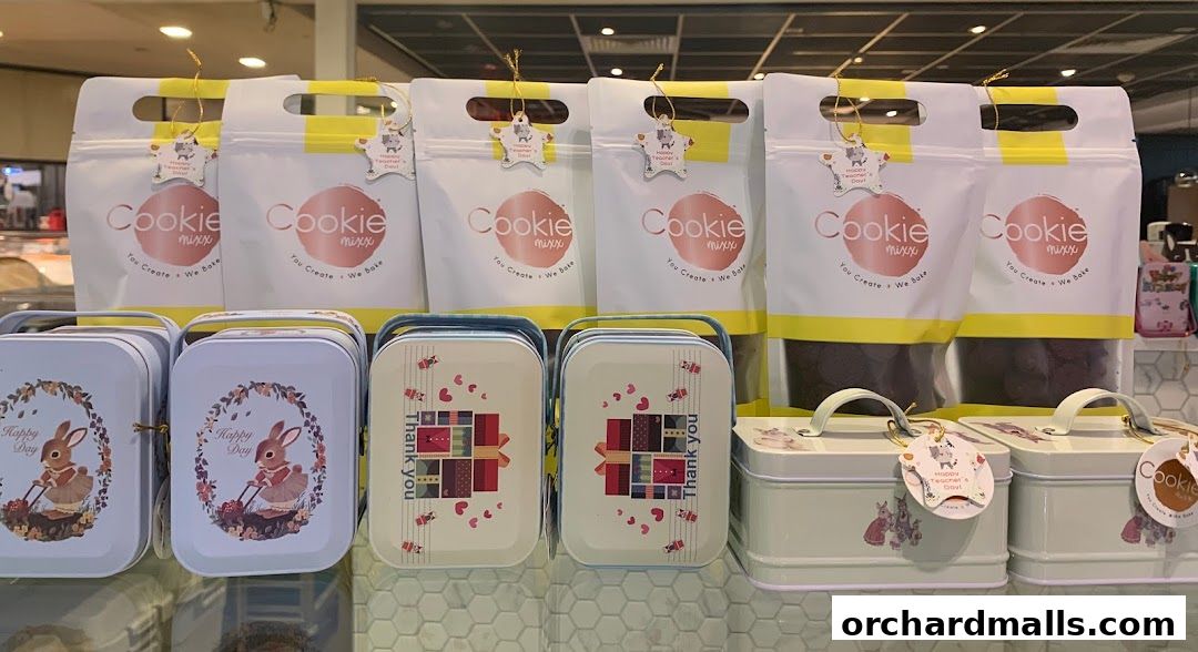 Cookie Mixx shop display featuring various cookie tins and gift bags.