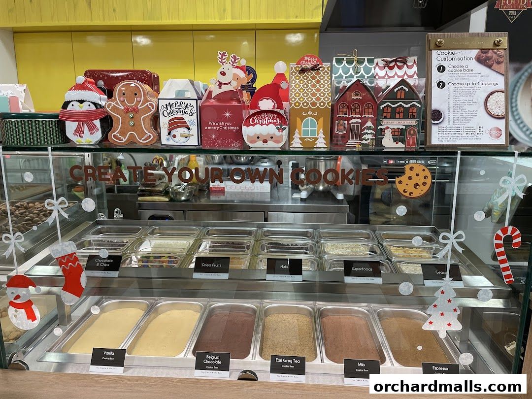 A display case filled with cookie ingredients and festive Christmas decorations.