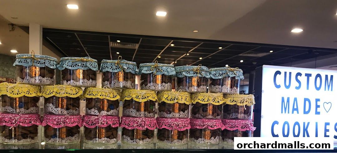 Jars of cookies are displayed on shelves with a 'Custom Made Cookies' sign.