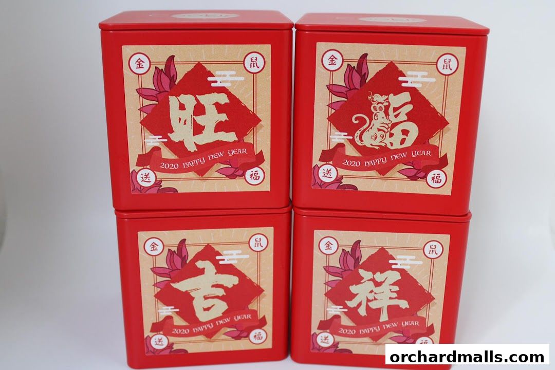 Four red square tins with Chinese New Year designs and text.