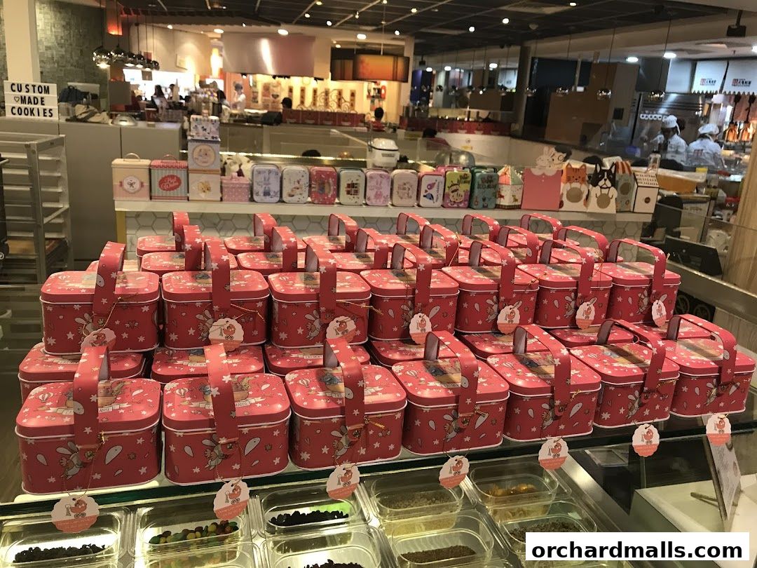 Rows of decorative cookie tins and baskets filled with treats at Cookie Mixx.