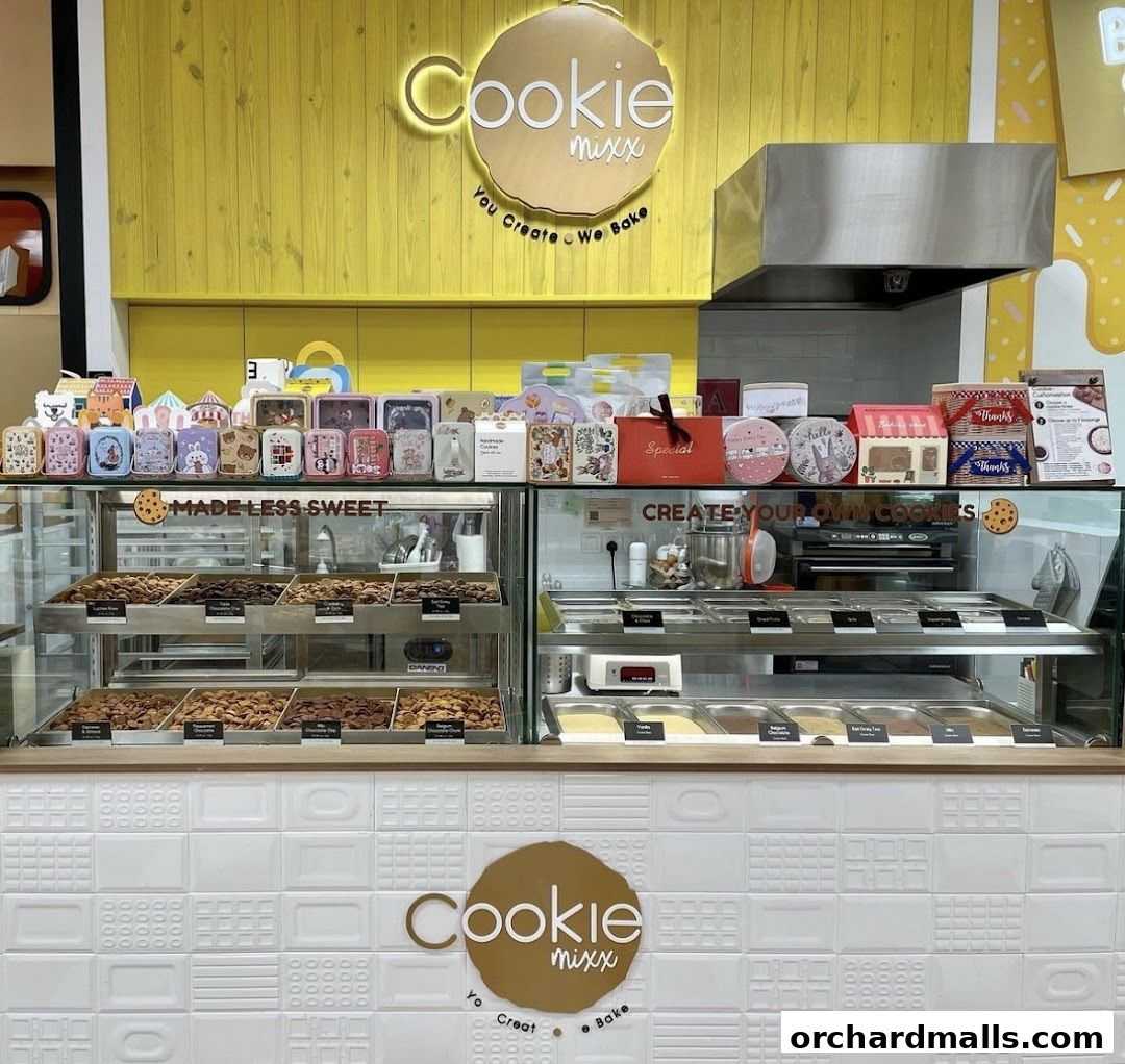 A brightly lit cookie shop with a display of cookies and ingredients for custom creations.
