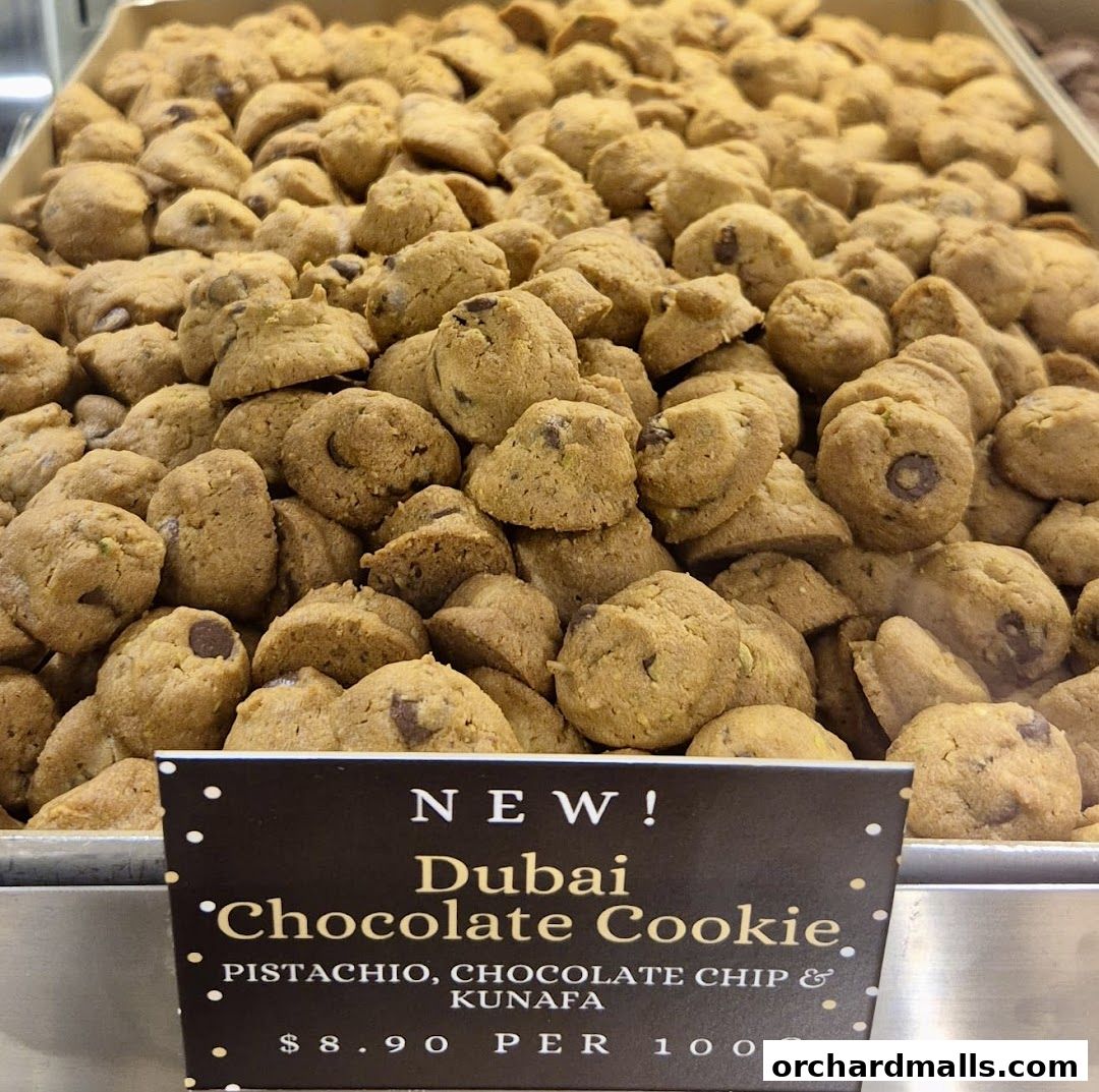 A close-up shot of a large tray filled with freshly baked chocolate chip cookies.