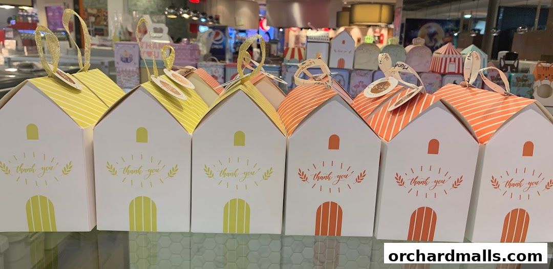 A row of house-shaped gift boxes with 'thank you' messages and decorative ribbons.