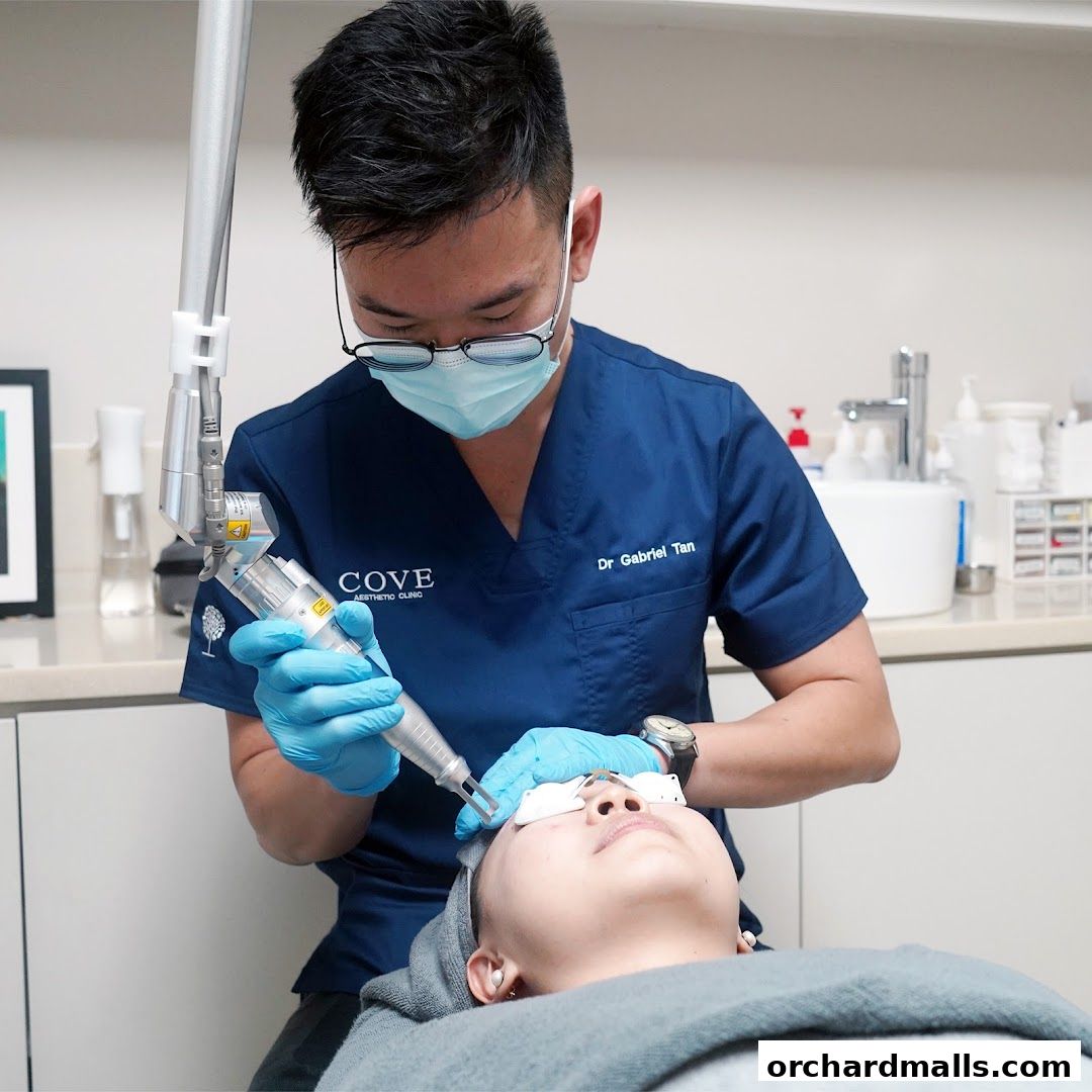A doctor performs a laser treatment on a patient's face at Cove Aesthetic Clinic.