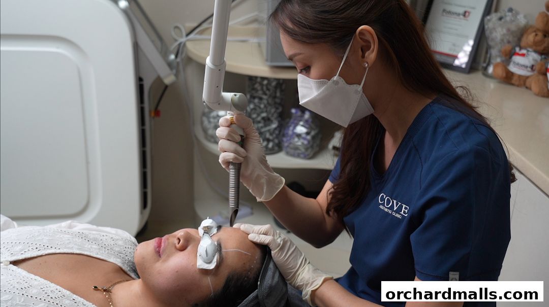 Aesthetic clinic professional performing a laser treatment on a client's face.