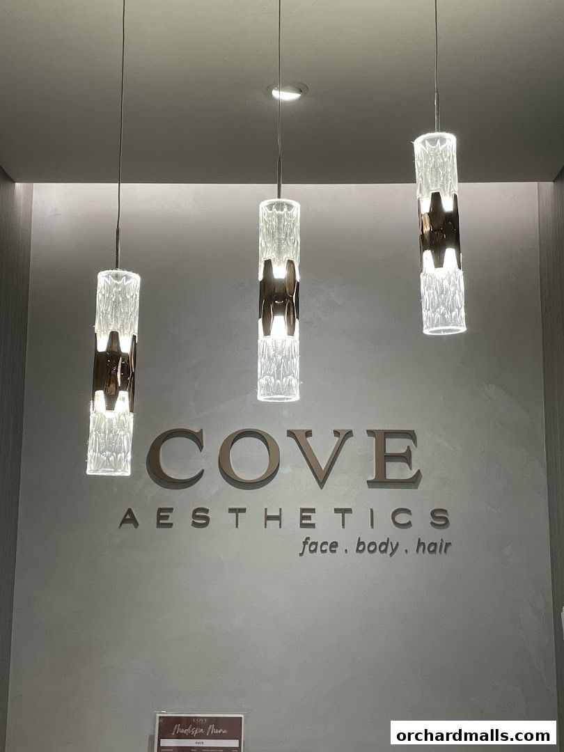 Elegant interior of Cove Aesthetics Medispa with modern pendant lights and signage.