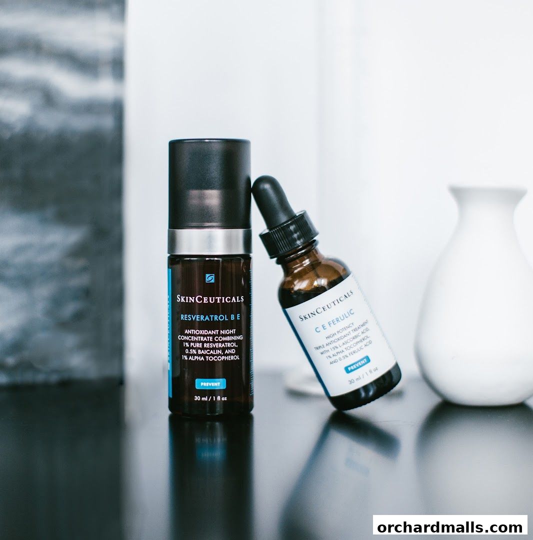 Two Skinceuticals skincare products, Resveratrol B E and C E Ferulic, displayed on a reflective surface.