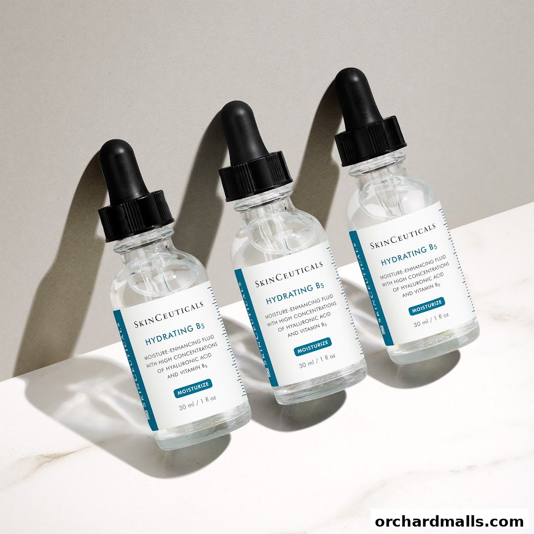 Three bottles of SkinCeuticals Hydrating B5 serum are displayed on a marble surface.
