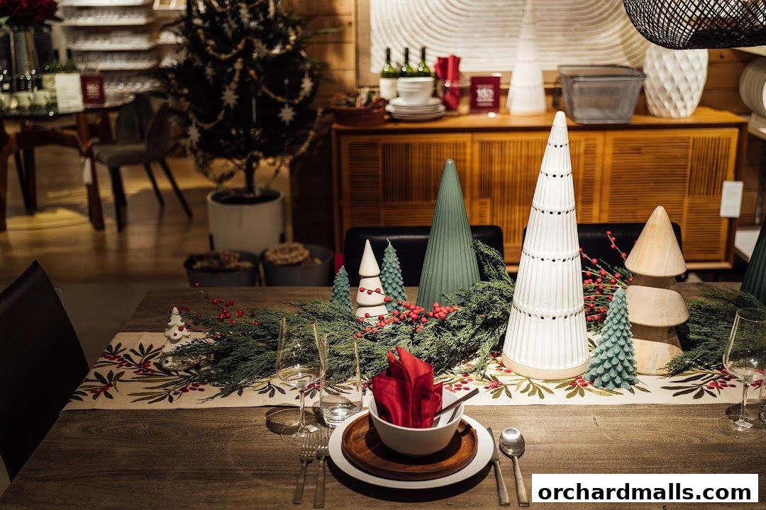 A festive dining table setting with Christmas tree-shaped decor and greenery.