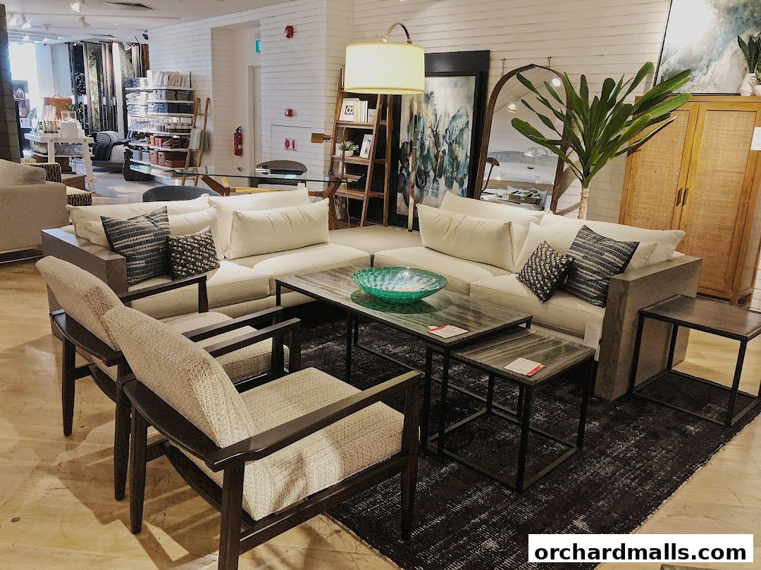 A modern living room setup with a sectional sofa, coffee tables, chairs, and decor.