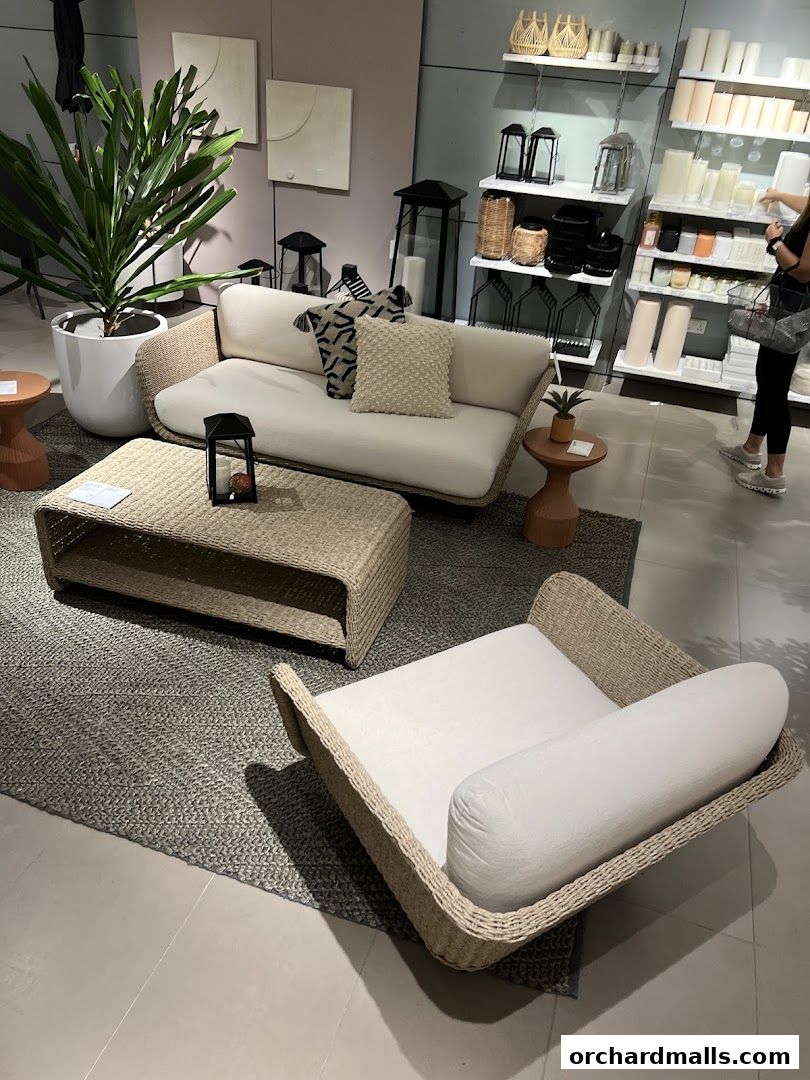A stylish living room setup with a sofa, coffee table, armchair, and decorative items.
