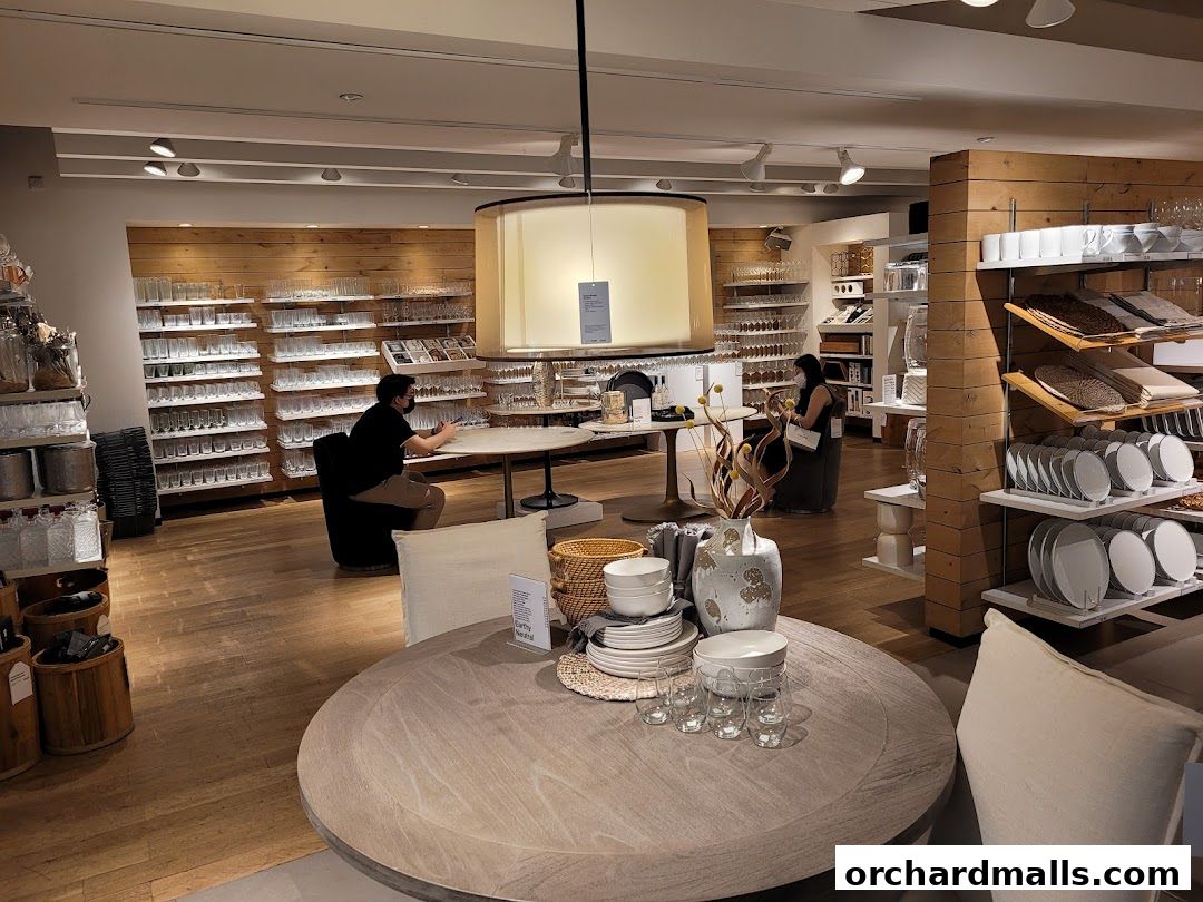 Interior view of Crate and Barrel showcasing dining ware, glassware, and home decor items.