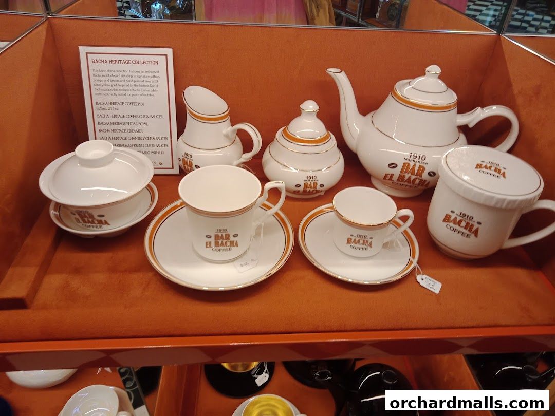 A display of elegant white and gold Bacha coffee set items from Crate and Barrel.