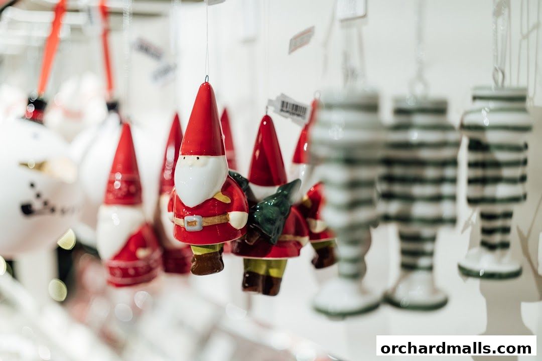Close-up of festive Christmas ornaments, including gnomes and striped figures, hanging indoors.