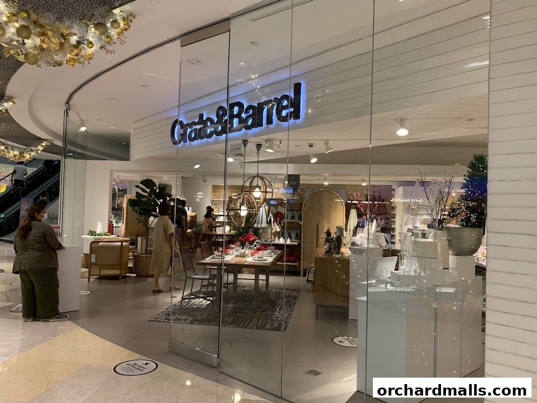 The Crate and Barrel store entrance with festive decorations and displays of home goods.