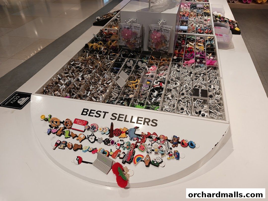 A display of various colorful charms and accessories for shoes, labeled 'BEST SELLERS'.