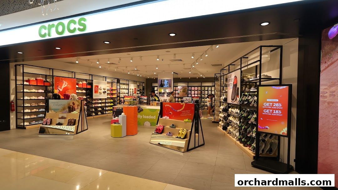 Interior view of a Crocs shoe store showcasing a wide variety of footwear and promotional displays.