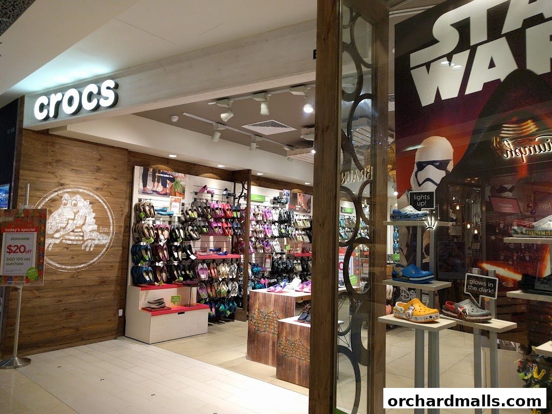 The Crocs store entrance displays a wide variety of colorful footwear and a Star Wars themed window display.