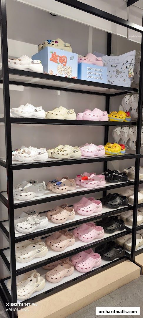 Shelves filled with colorful Crocs shoes in various styles and colors.