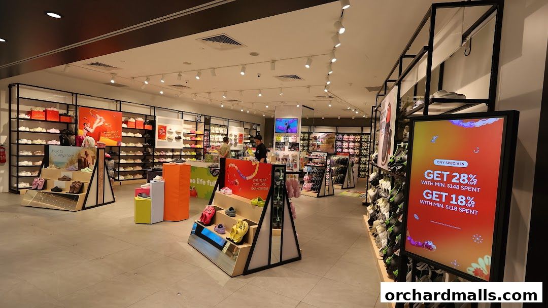 Interior view of a Crocs store showcasing various footwear and promotional displays.