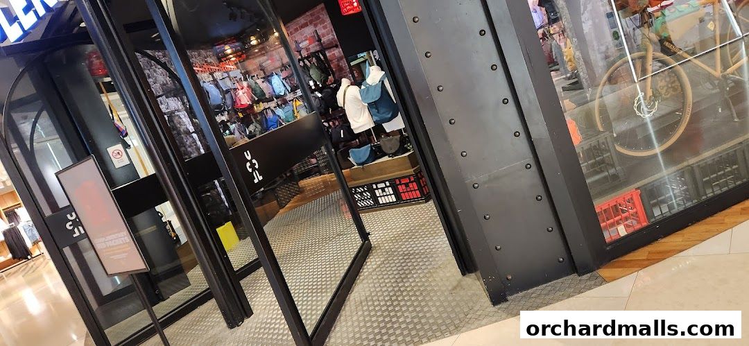 The entrance of a Crumpler shop displaying various bags and a bicycle.