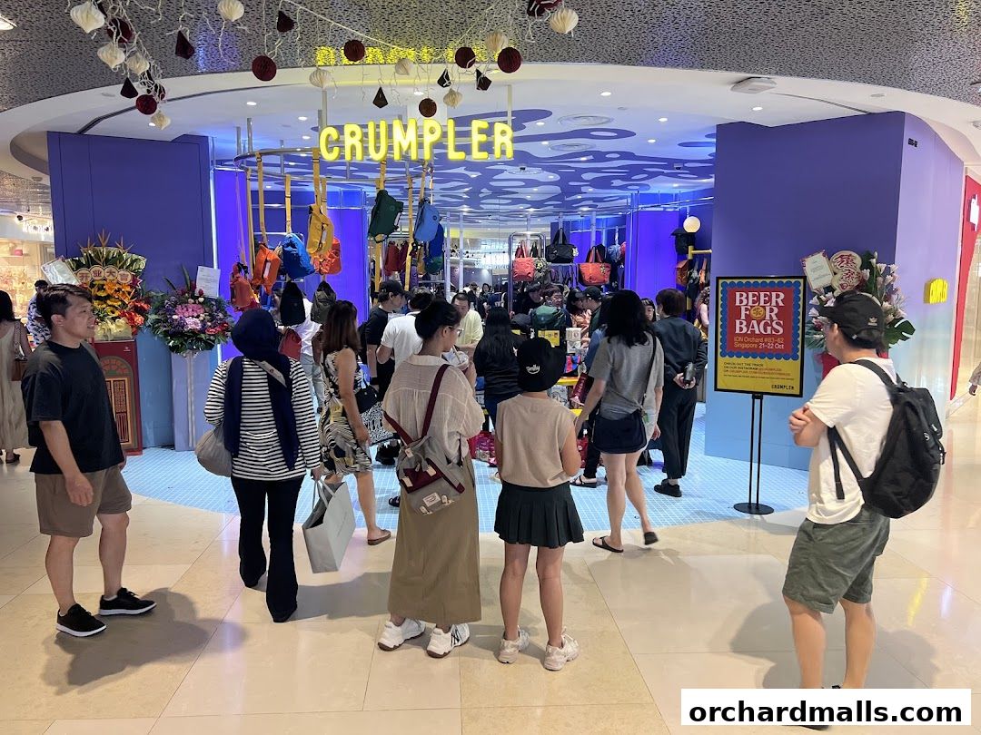 People browse bags at the vibrant Crumpler store entrance with colorful displays.