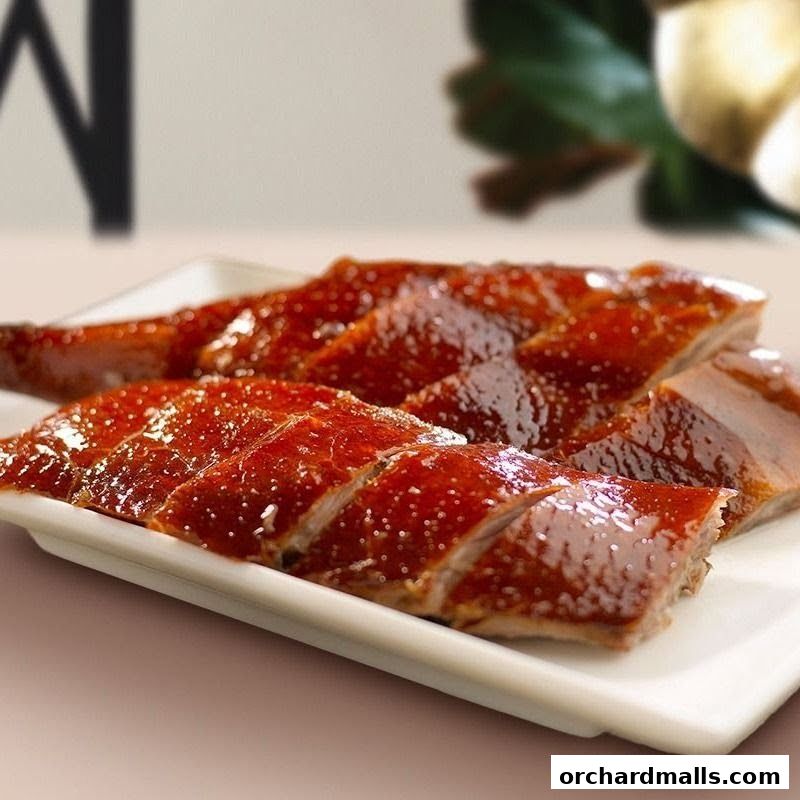 A close-up shot of perfectly roasted, sliced duck on a white platter.