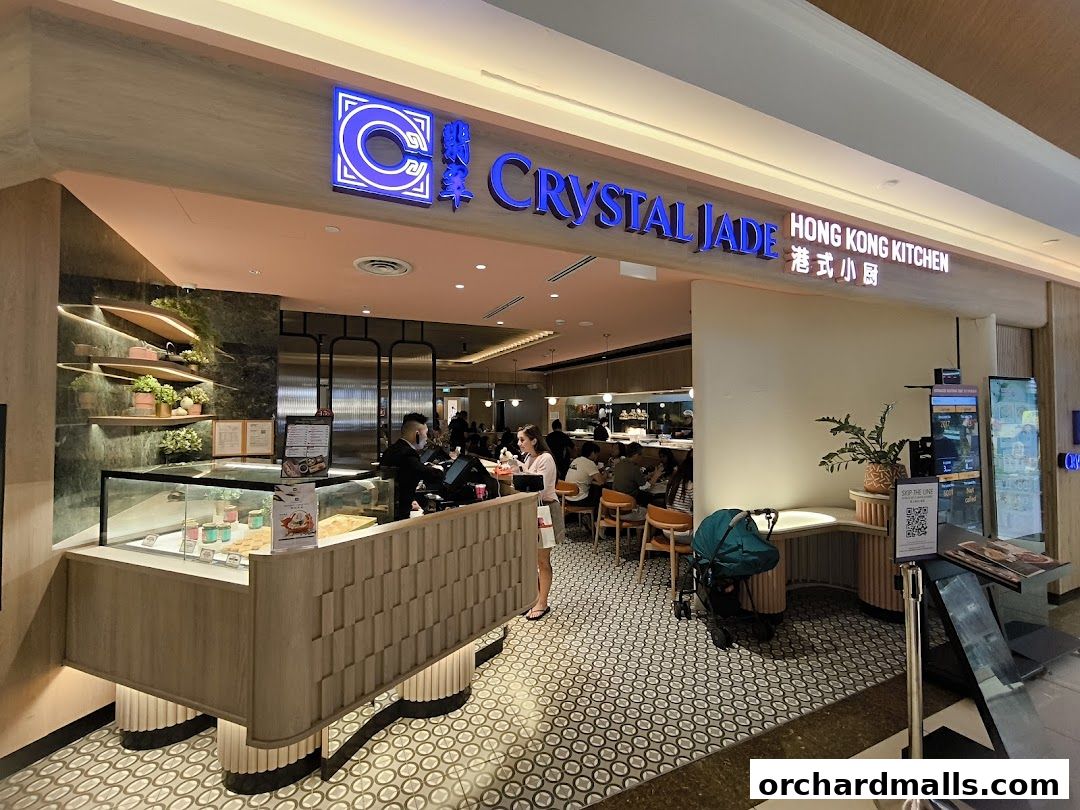 Exterior view of Crystal Jade Hong Kong Kitchen with a display counter and seating area visible.