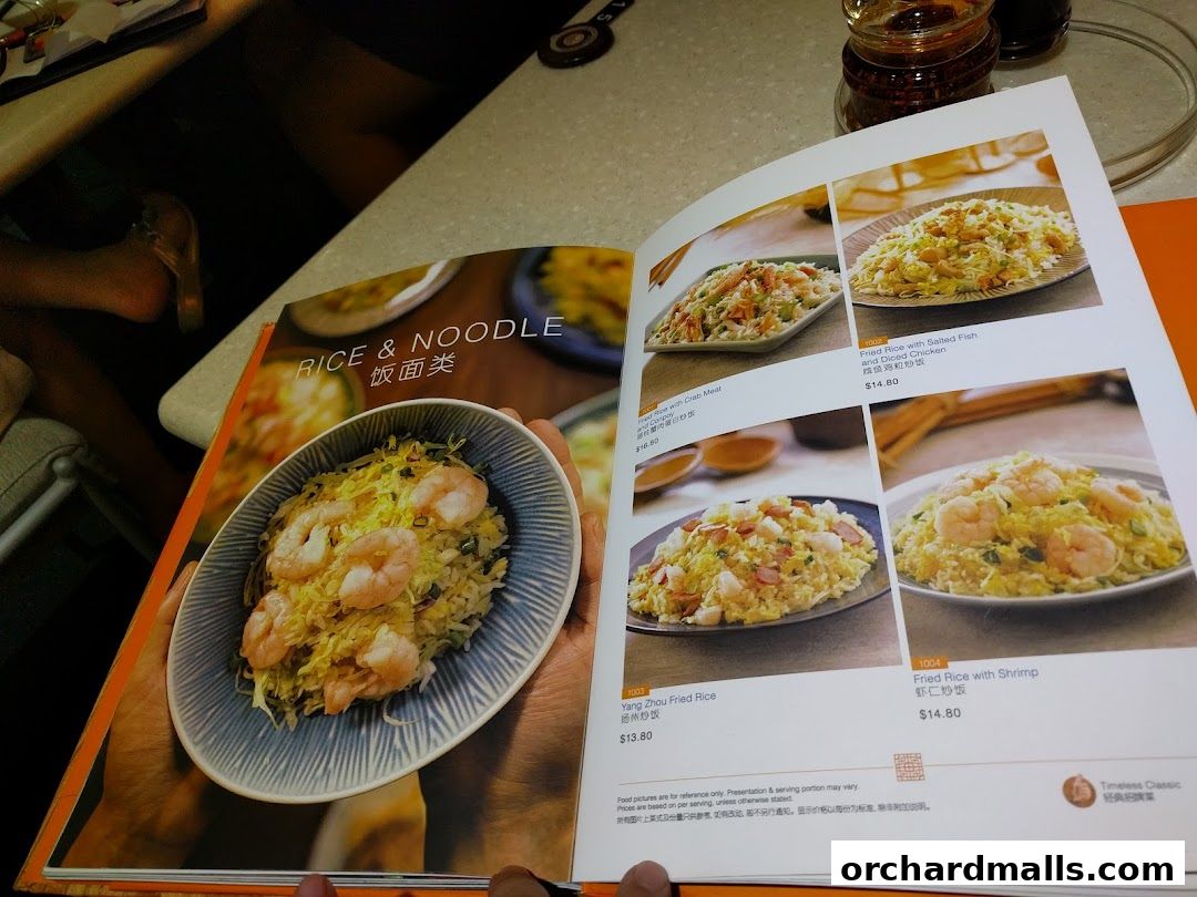 A menu page from Crystal Jade Palace showcasing rice and noodle dishes with enticing food photography.