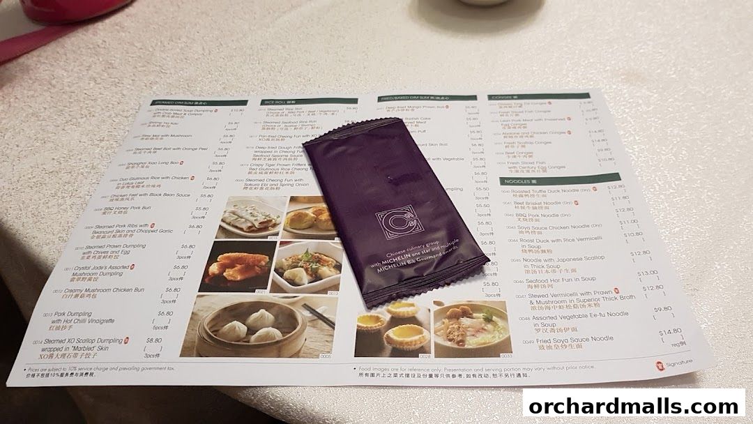 A menu from Crystal Jade Palace featuring dim sum and noodle dishes with accompanying images.