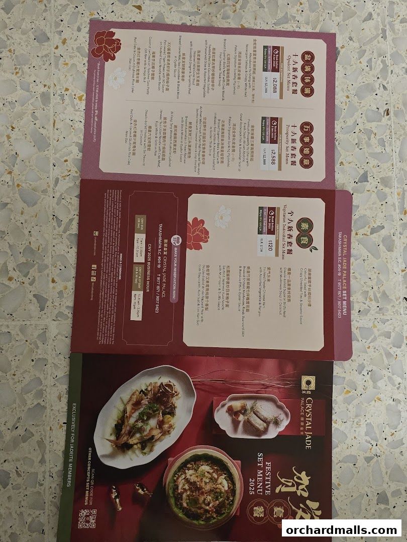 A folded menu from Crystal Jade Palace showcasing festive set menus for Chinese New Year.