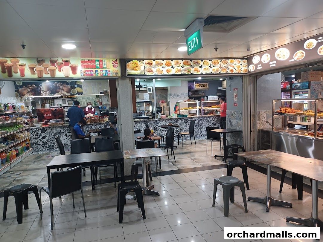 Interior view of Curryleaf Multi Cuisine Pte Ltd, showing dining area and food display.