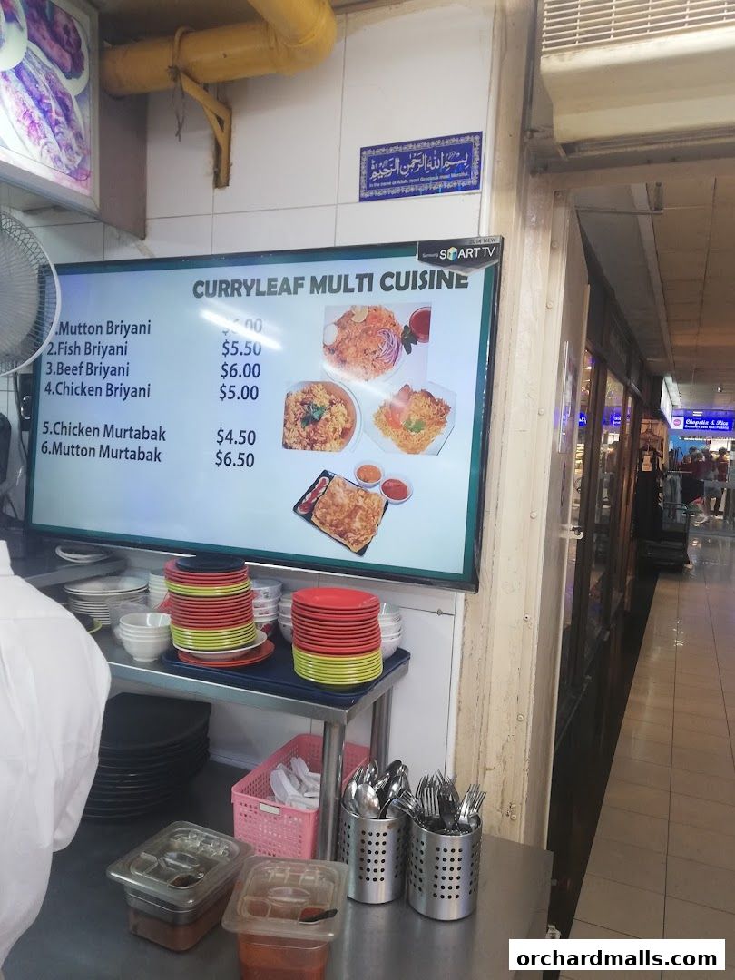 A digital menu board displaying various biryani and murtabak dishes with prices.