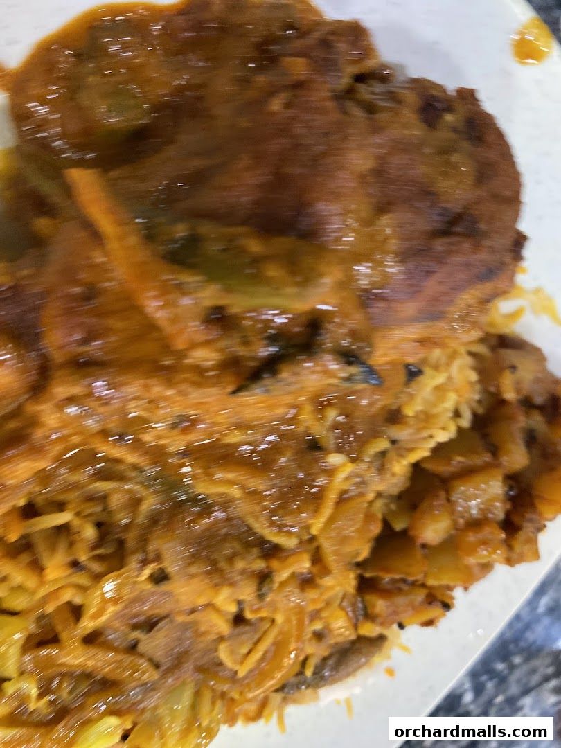 A close-up shot of a delicious Indian dish with rice and curry.