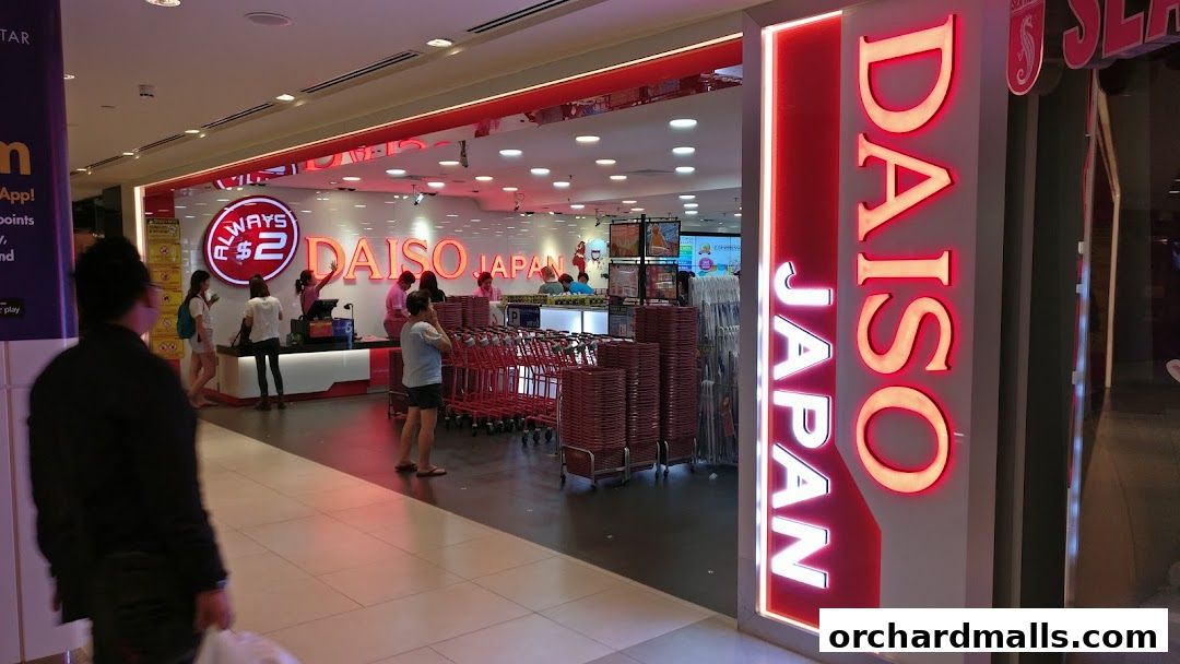 The entrance of a brightly lit Daiso Japan store with a prominent vertical sign and shopping carts.