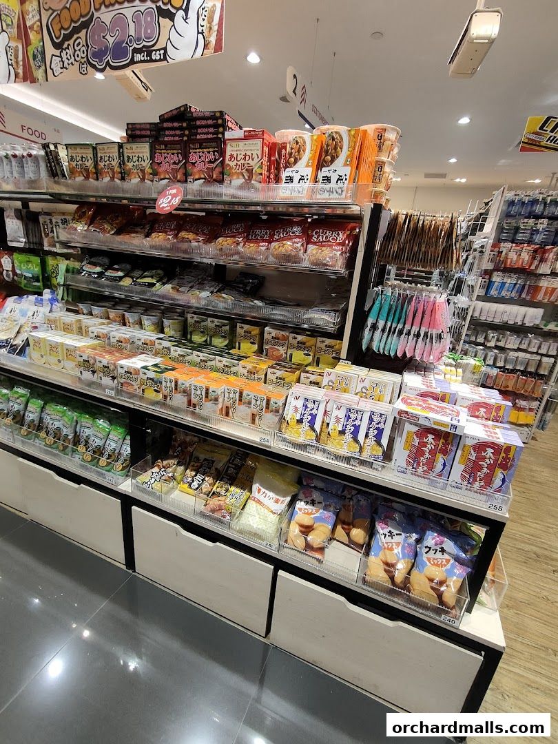 Shelves stocked with various Japanese snacks, instant foods, and kitchenware.