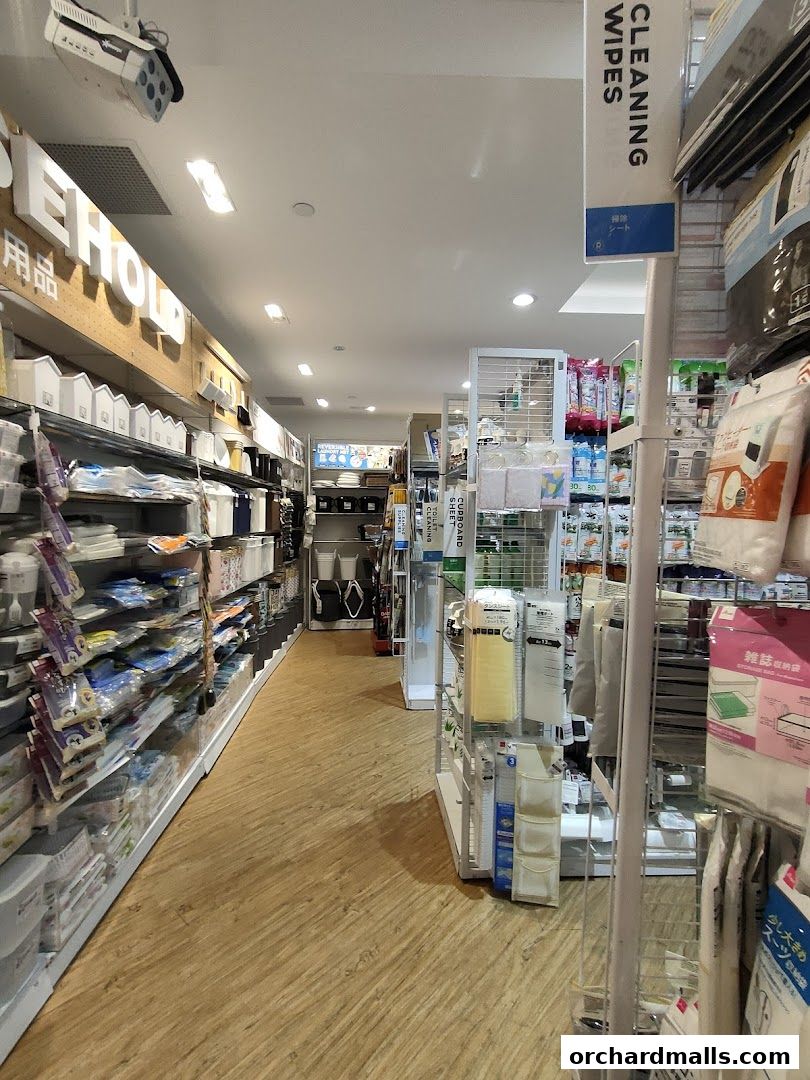 A view down an aisle of a Daiso store, showcasing various household and cleaning products.