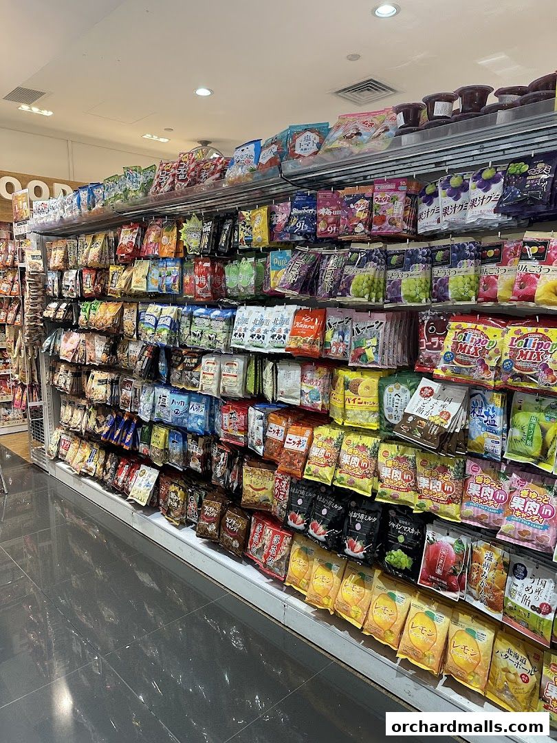 Shelves stocked with a wide variety of Japanese snacks and candies, including gummies and hard candies.