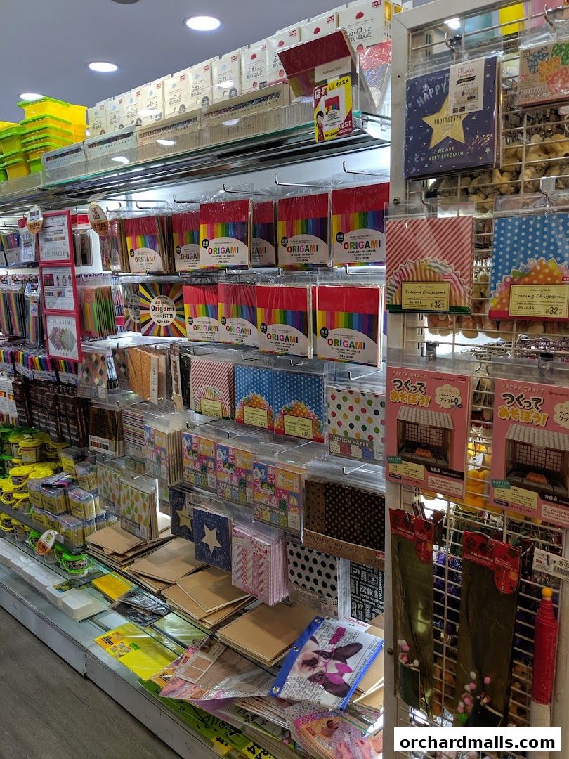 A wide selection of colorful origami paper, craft supplies, and stationery items displayed on shelves.