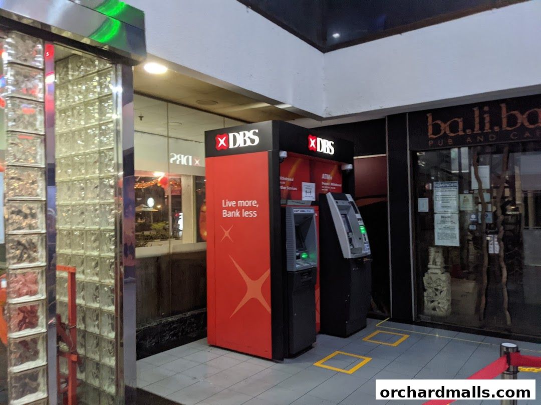 Two DBS ATMs are located next to a pub and cafe in a shopping mall.