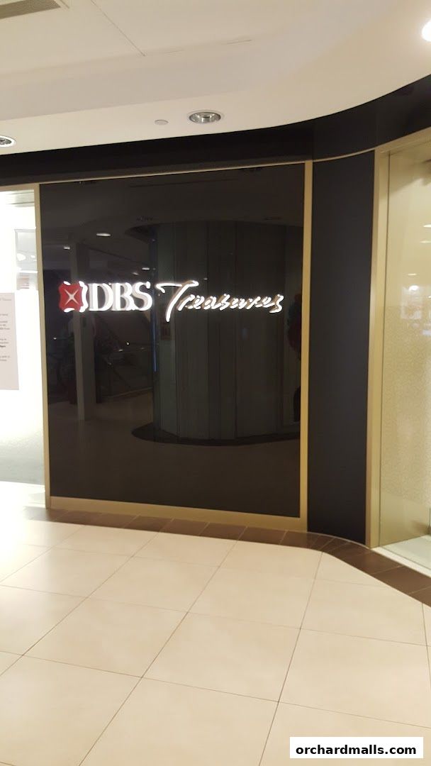 The entrance to DBS Treasures Ngee Ann City, featuring a sleek black facade with illuminated signage.