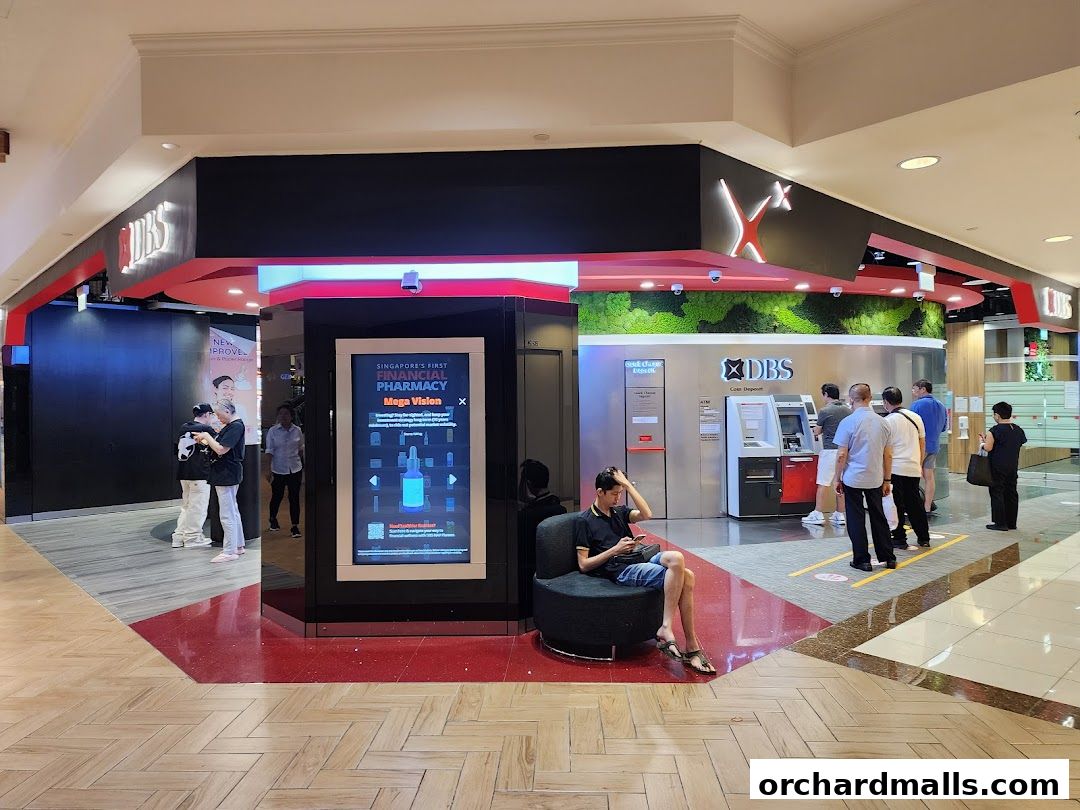 DBS bank branch with ATMs and a digital display in a shopping mall.