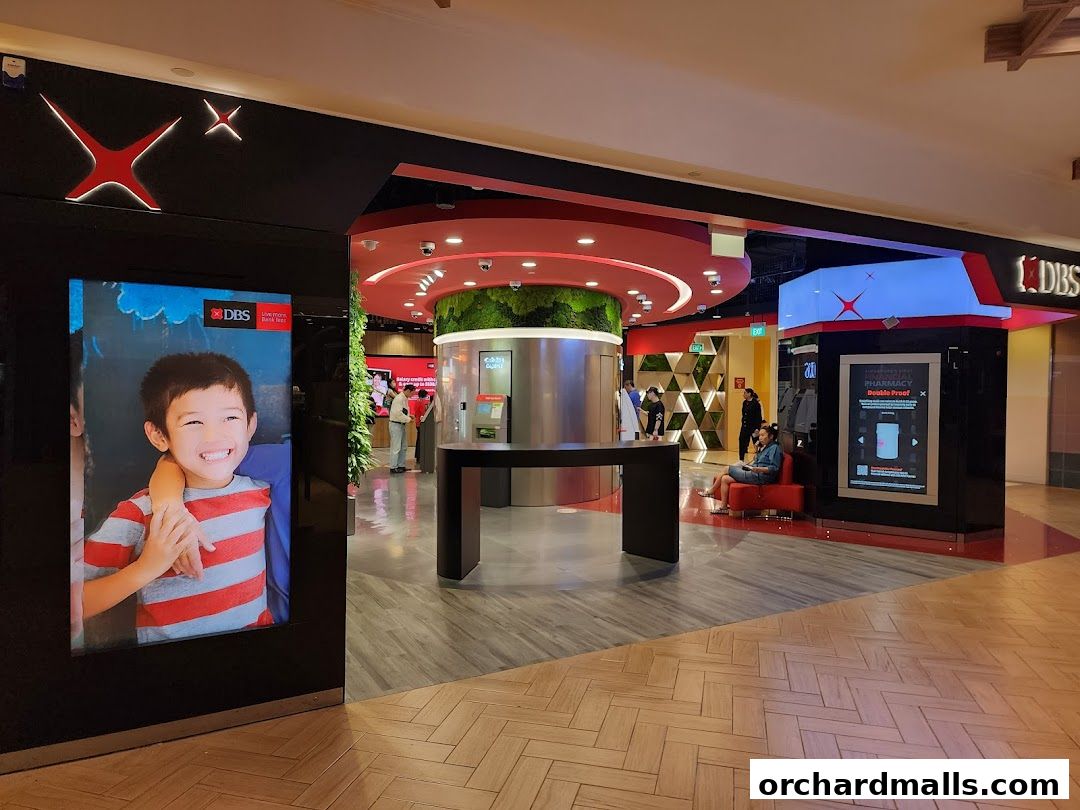 The entrance of DBS Treasures Ngee Ann City bank branch with digital displays.