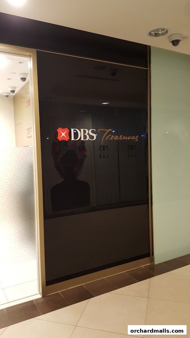 The entrance to DBS Treasures Ngee Ann City, featuring a sleek black glass facade.