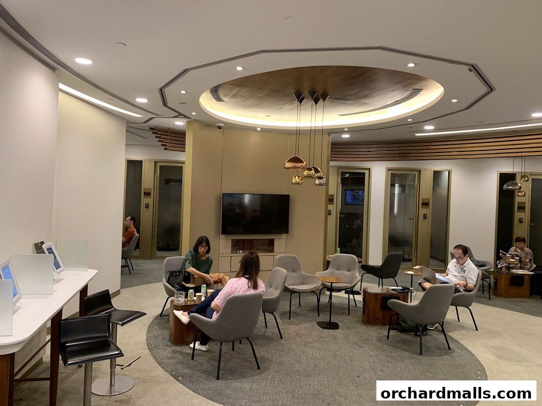 Interior of a modern lounge area with people relaxing and working.