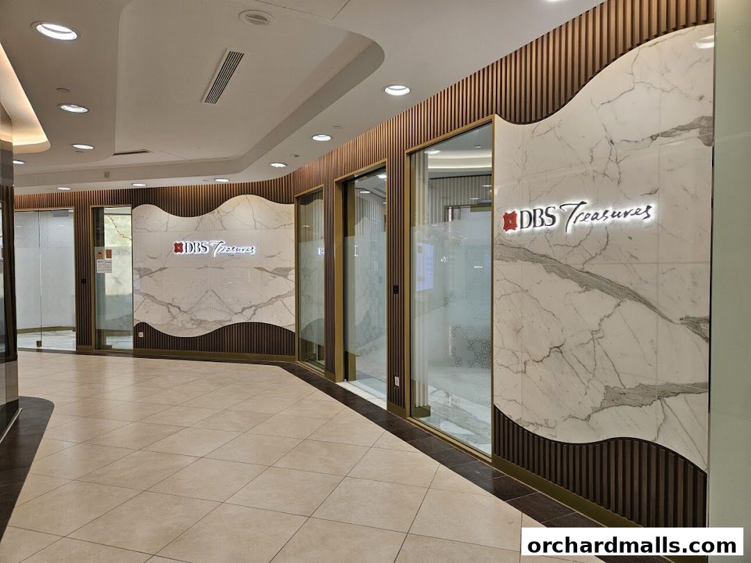 The entrance to DBS Treasures Ngee Ann City, featuring elegant marble and wood paneling.
